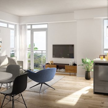 Spruce Trails townhome interior with warm wood cabinetry and natural light